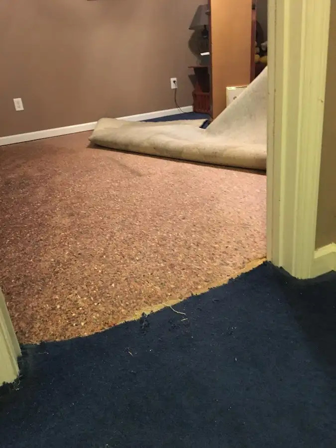 Carpet pad removal revealing water damage during Water Mitigation Services in Ladera Heights